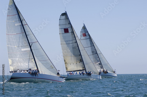 View of three yachts compete in team sailing event