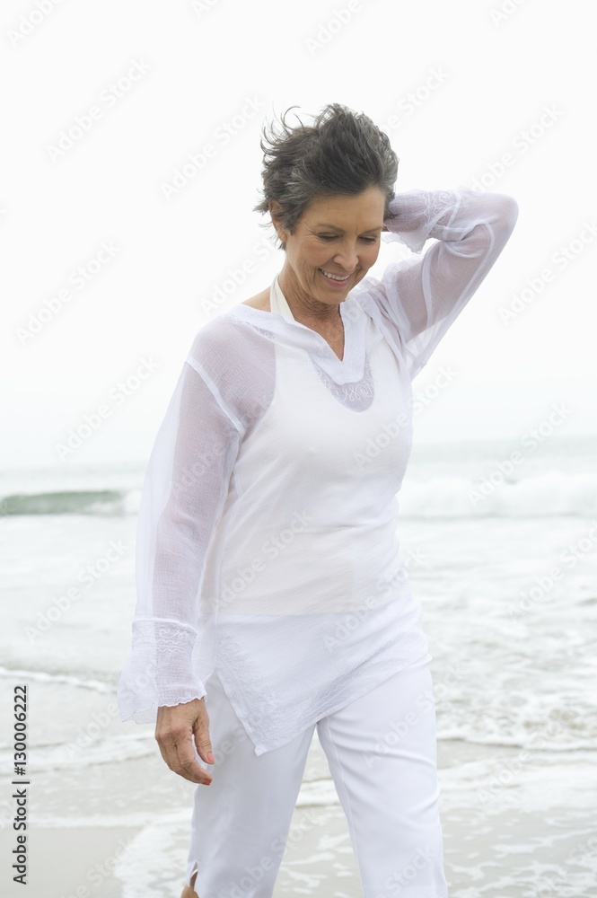 Happy woman in white casual clothing walking at beach Happy woman in white casual clothing walking at beach