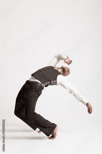 Full length of young man dancing jazz over white background