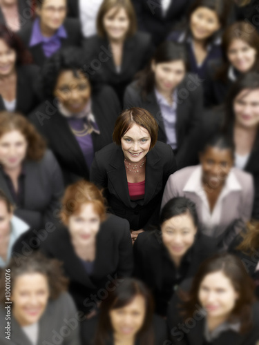 High angle view of a businesswoman standing amidst multiethnic businesspeople