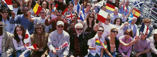 Happy group of people waving flags of different countries