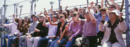 Panoramic shot of crowd cheering in stadium