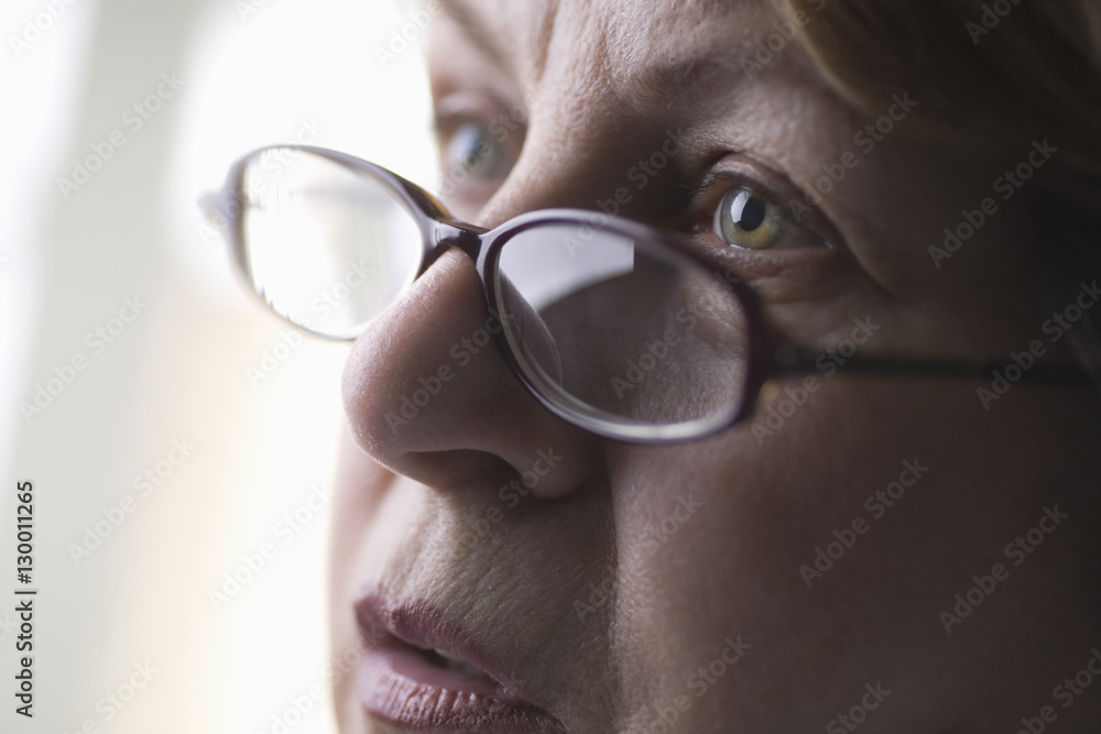 Closeup of senior woman wearing glasses while looking away Closeup of senior woman wearing glasses while looking away
