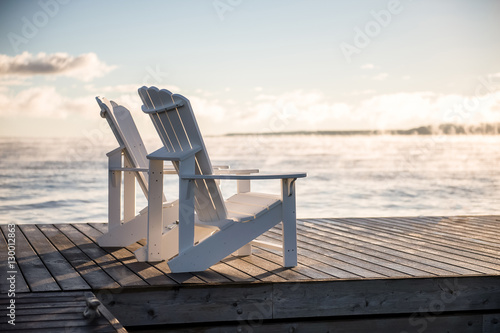 Canvas Print Adirondack Muskoka chairs on the dock at sunrise