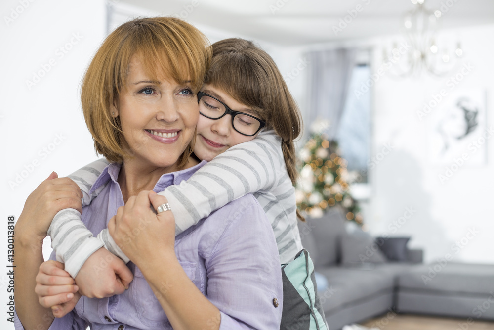 Loving daughter embracing mother at home Loving daughter embracing mother at home