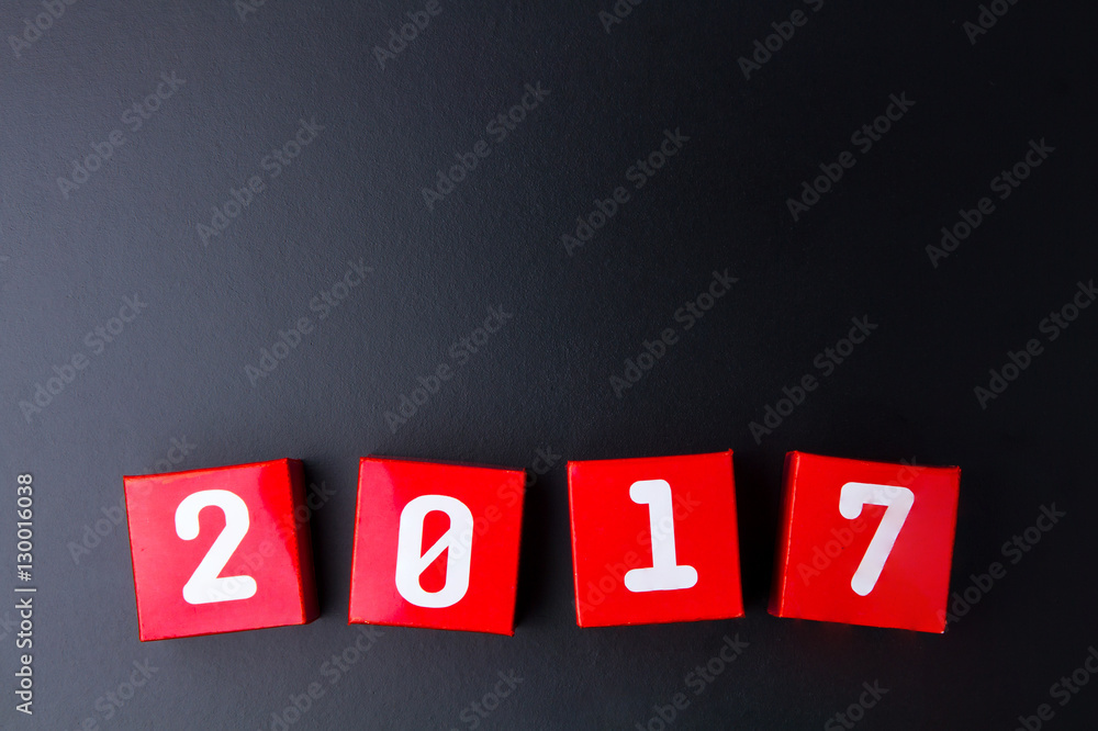 Obraz premium Happy new year 2017 number on red paper box cubes on black backg