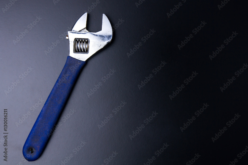 Pipe wrench construction tools on a black background with light Pipe wrench construction tools on a black background with light