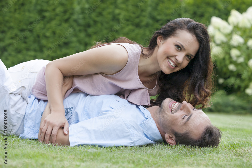 Playful young couple having leisure time in park Playful young couple having leisure time in park