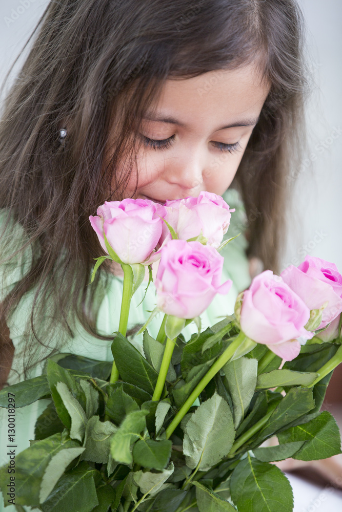 Cute girl smelling roses at home Cute girl smelling roses at home