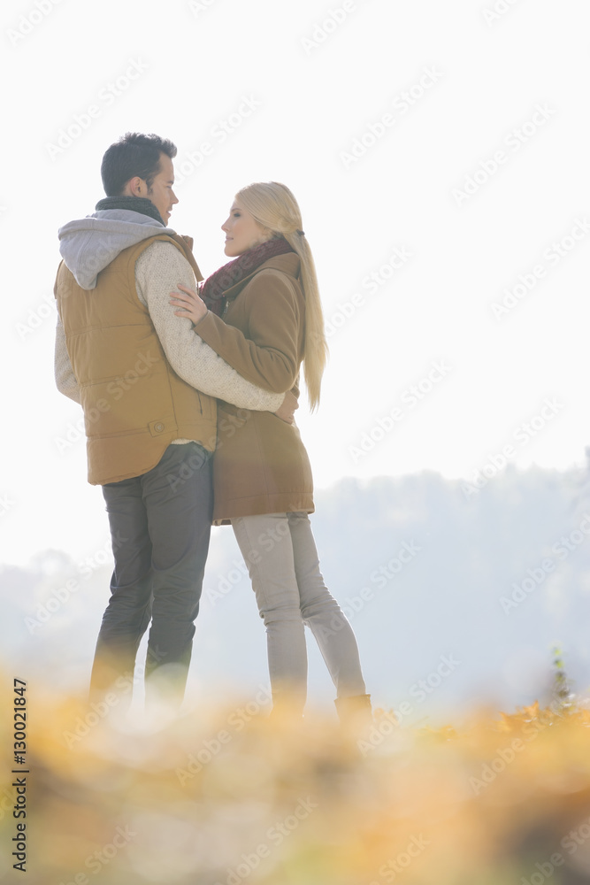 Couple hugging during autumn in park Couple hugging during autumn in park
