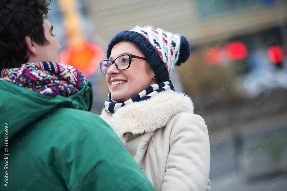 Obraz premium Romantic couple looking at each other in city during winter