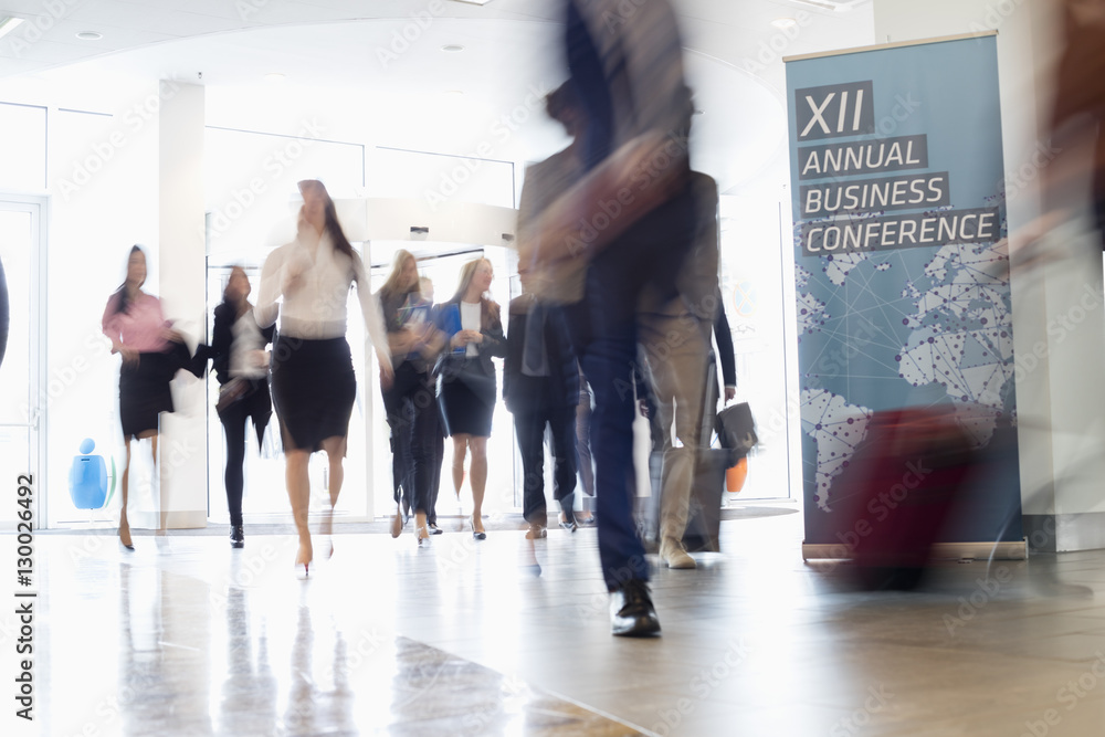Fototapeta premium Blurred motion of business people walking in convention center