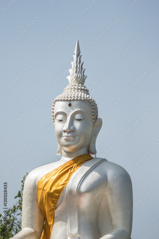 The White buddha status on blue sky background , Thailand