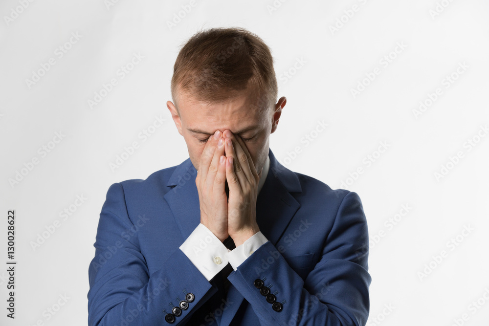 Businessman with holding his head in hands in shame Businessman with holding his head in hands in shame