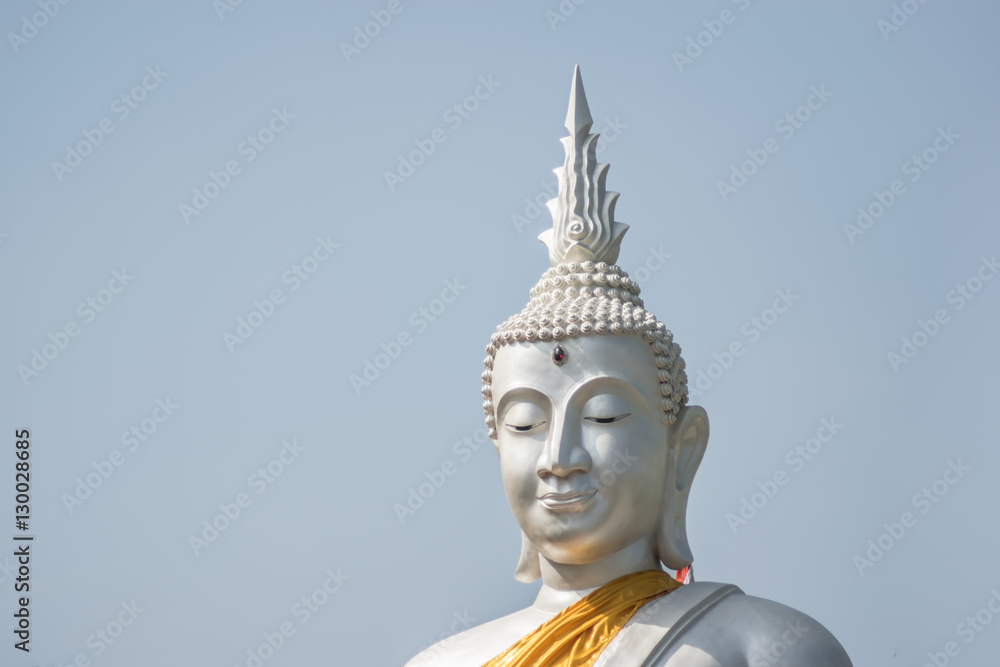 The White buddha status on blue sky background , Thailand