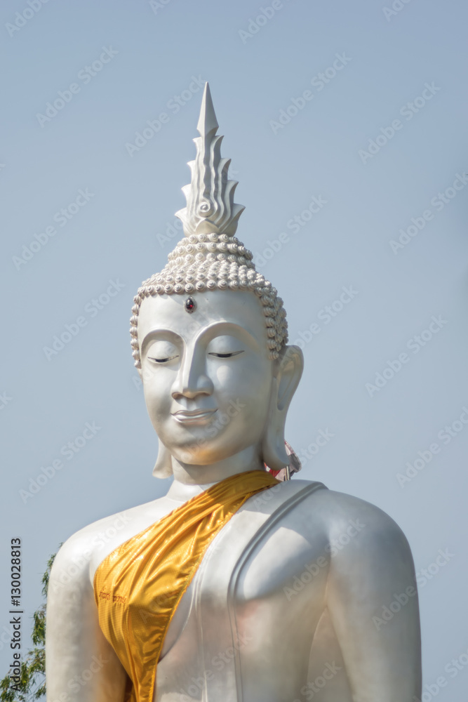 The White buddha status on blue sky background , Thailand