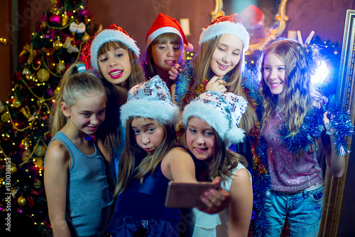 Group of cheerful young girls celebrating Christmas. Selfie