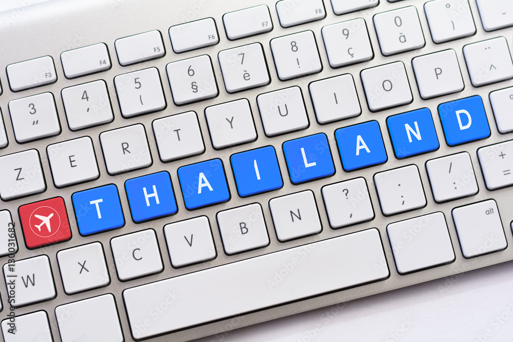 THAILAND writing on white keyboard with a aircraft sketch THAILAND writing on white keyboard with a aircraft sketch