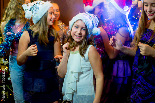 Group of cheerful young girls celebrating Christmas