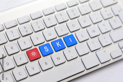 SKI writing on white keyboard with a snowflake sketch