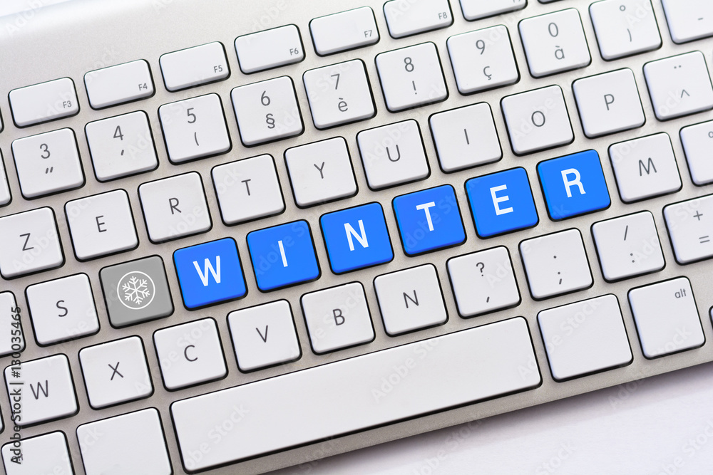 WINTER writing on white keyboard with a snowflake sketch WINTER writing on white keyboard with a snowflake sketch