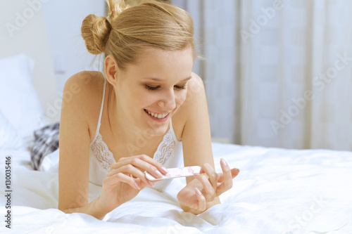 Young woman filing her nails