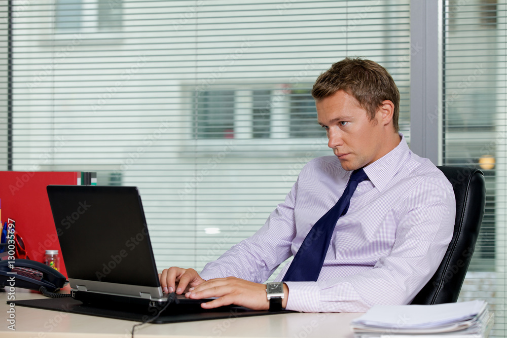 Businessman using laptop at office Businessman using laptop at office