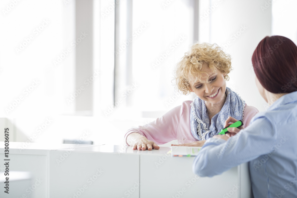 Businesswomen discussing in creative office Businesswomen discussing in creative office