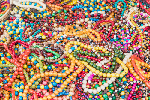 The pile of multicolored wooden necklaces
