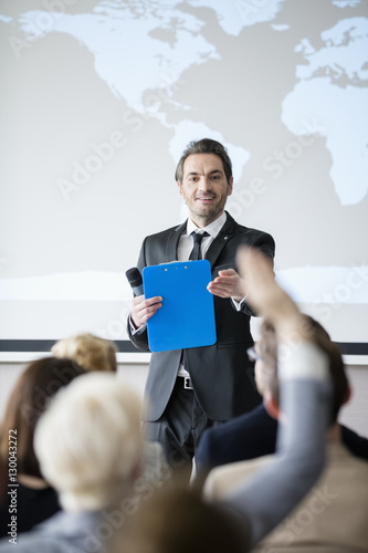 Public speaker asking questions to audience during seminar