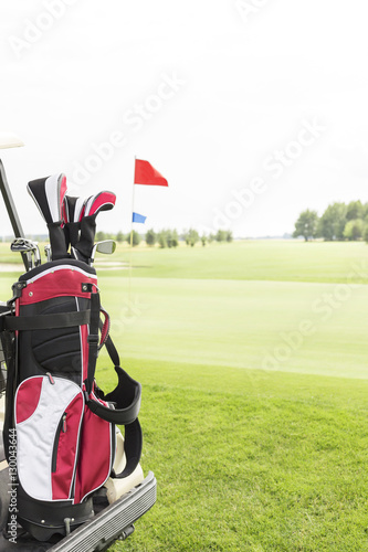 Golf club bag at golf course against clear sky