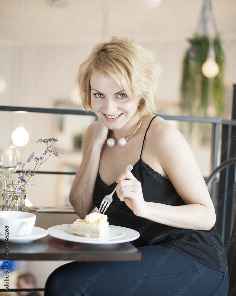 Portrait of happy young woman eating cake at cafe Portrait of happy young woman eating cake at cafe