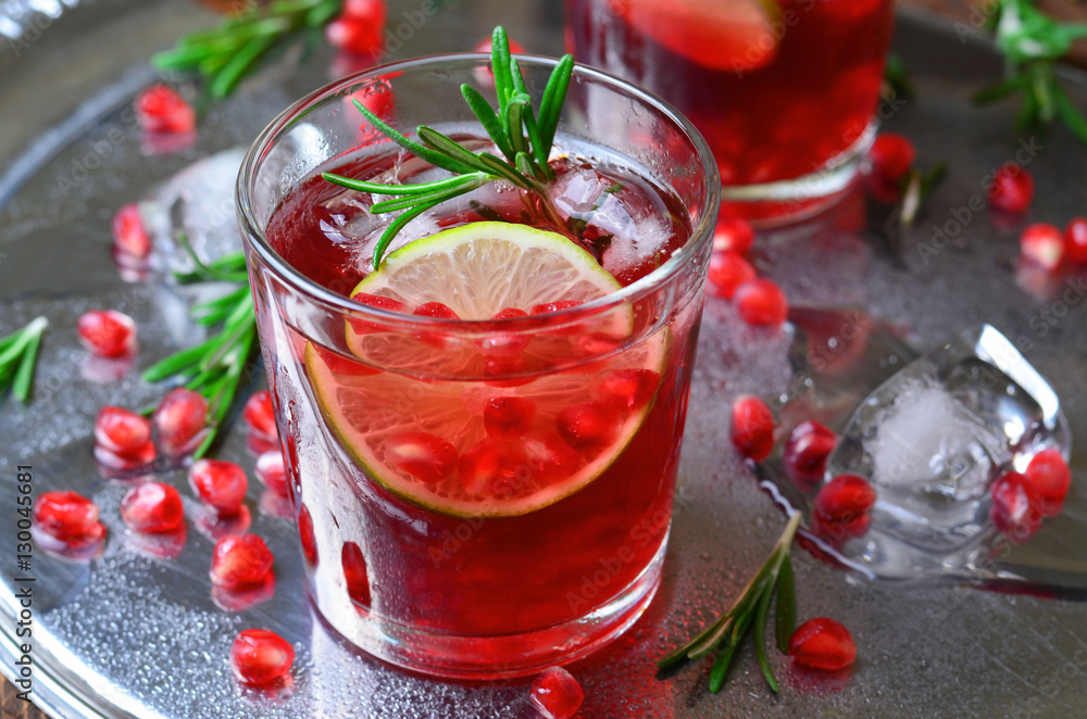 Pomegranate Cocktail Decorated with Lime, Rosemary and Ice Pomegranate Cocktail Decorated with Lime, Rosemary and Ice