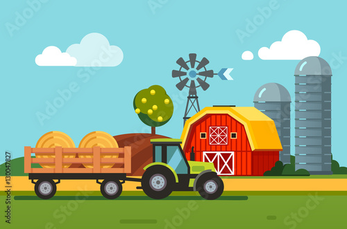 Tractor towing hay bales loaded to a trailer