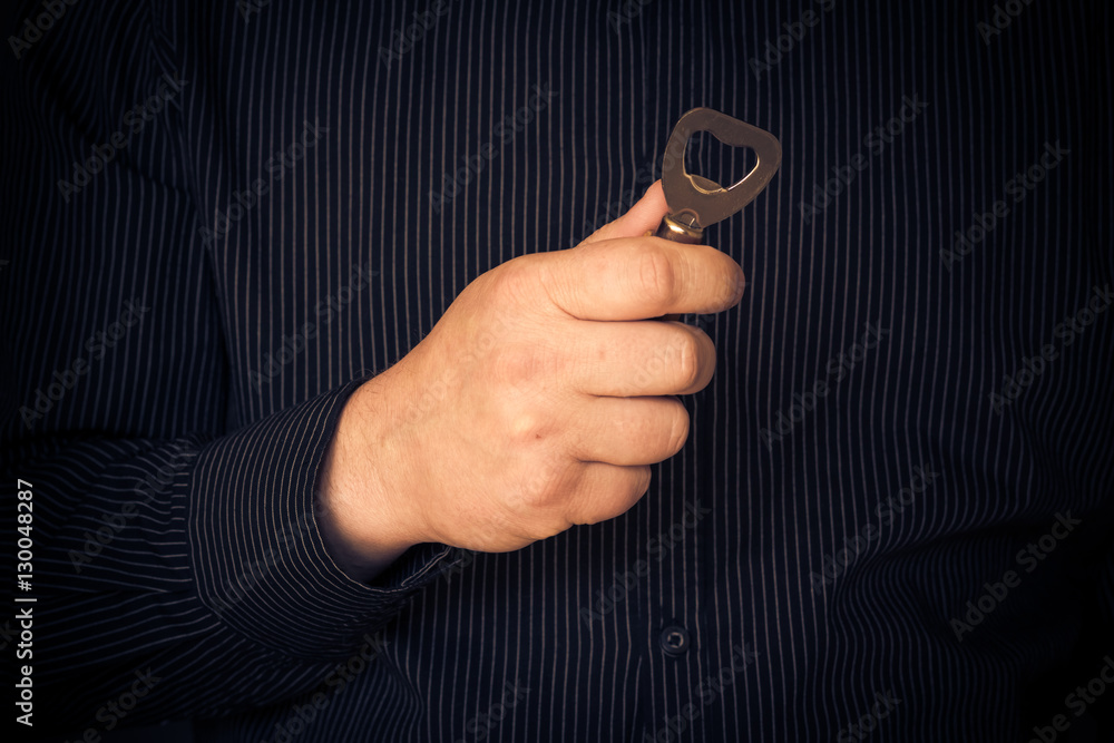Man holding bottle opener hand Man holding bottle opener hand