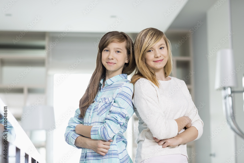 Portrait of cute sisters standing together at home Portrait of cute sisters standing together at home