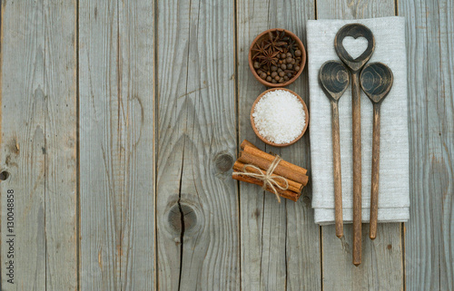 wooden spoons and set of spices on wood background