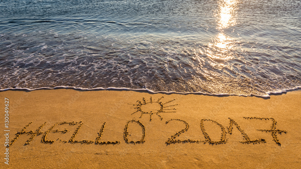 Fototapeta premium Hello New Year 2017 concept, lettering on the beach