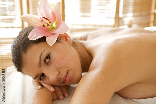 Portrait of young woman relaxing on massage table