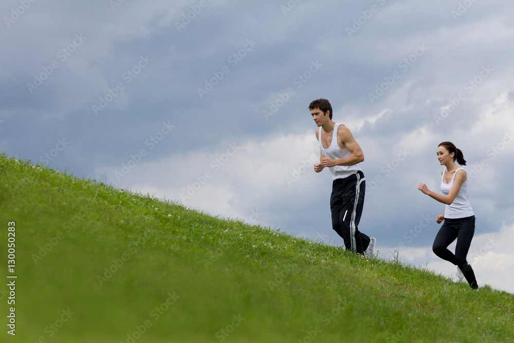 Young couple exercising in park Young couple exercising in park