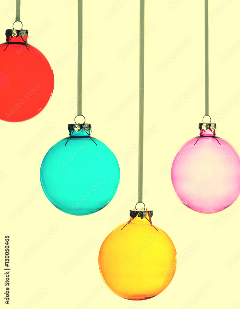 Four Christmas baubles on yellow vintage background