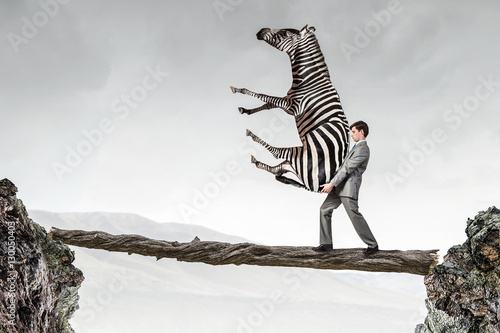 Businessman carrying zebra . Mixed media