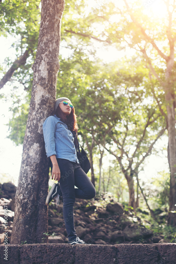 Attractive girl standing against tree, While traveling. Attractive girl standing against tree, While traveling.