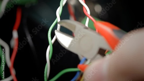 macro of cutting the red wire with pliers