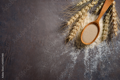 Baking background with dry yeast in a spoon