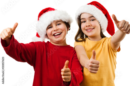 Christmas time - girl and boy with Santa Claus Hat showing OK sign