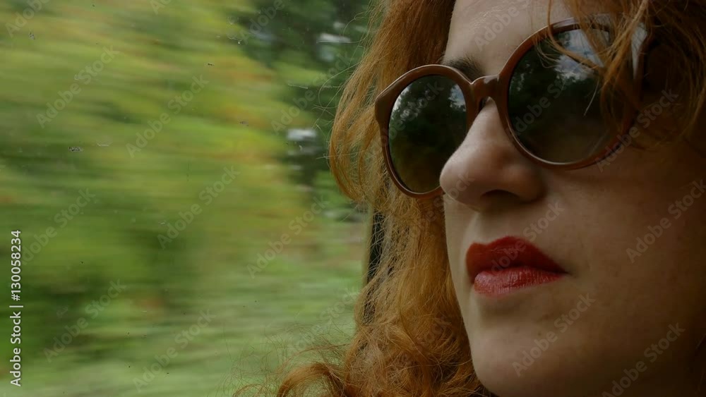 pensive woman looking outside the window sitting on the train pensive woman looking outside the window sitting on the train