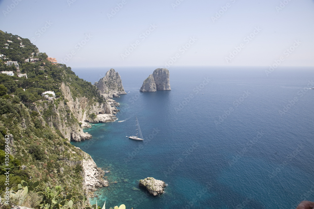 The coast line of the island of Capri, with the famous Faraglioni rocks on the back ground, Capri, Bay of Naples The coast line of the island of Capri, with the famous Faraglioni rocks on the back ground, Capri, Bay of Naples