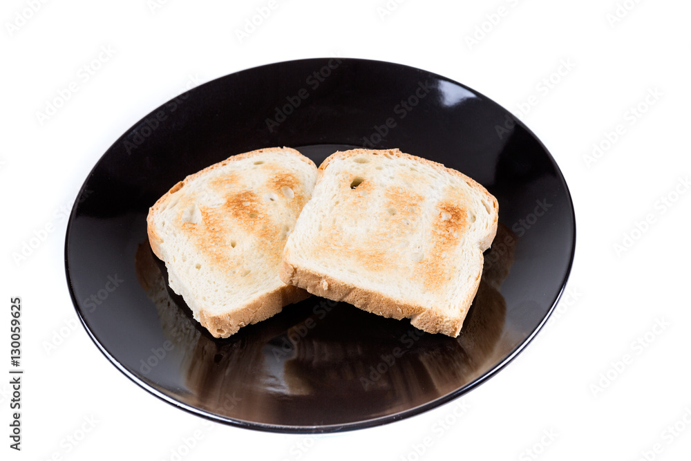 Two whole grain slices of bread toasted on a ceramic plate isolated on white background