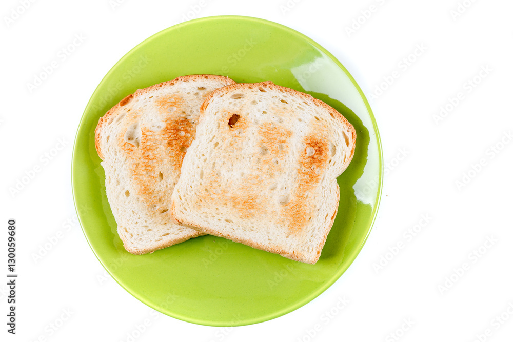 Two whole grain slices of bread toasted on a ceramic plate isolated on white background Two whole grain slices of bread toasted on a ceramic plate isolated on white background